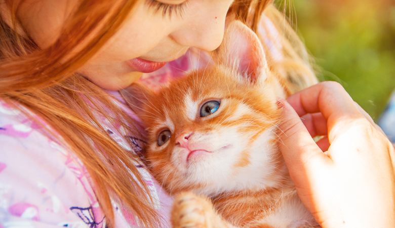 Girl cuddling with kitten