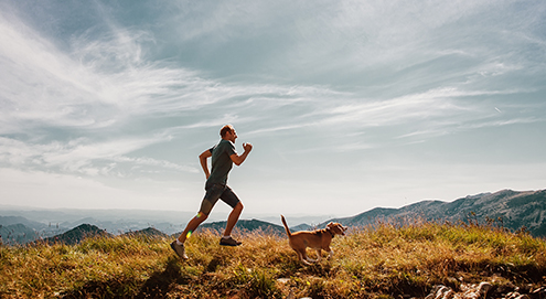 guy running with dog 